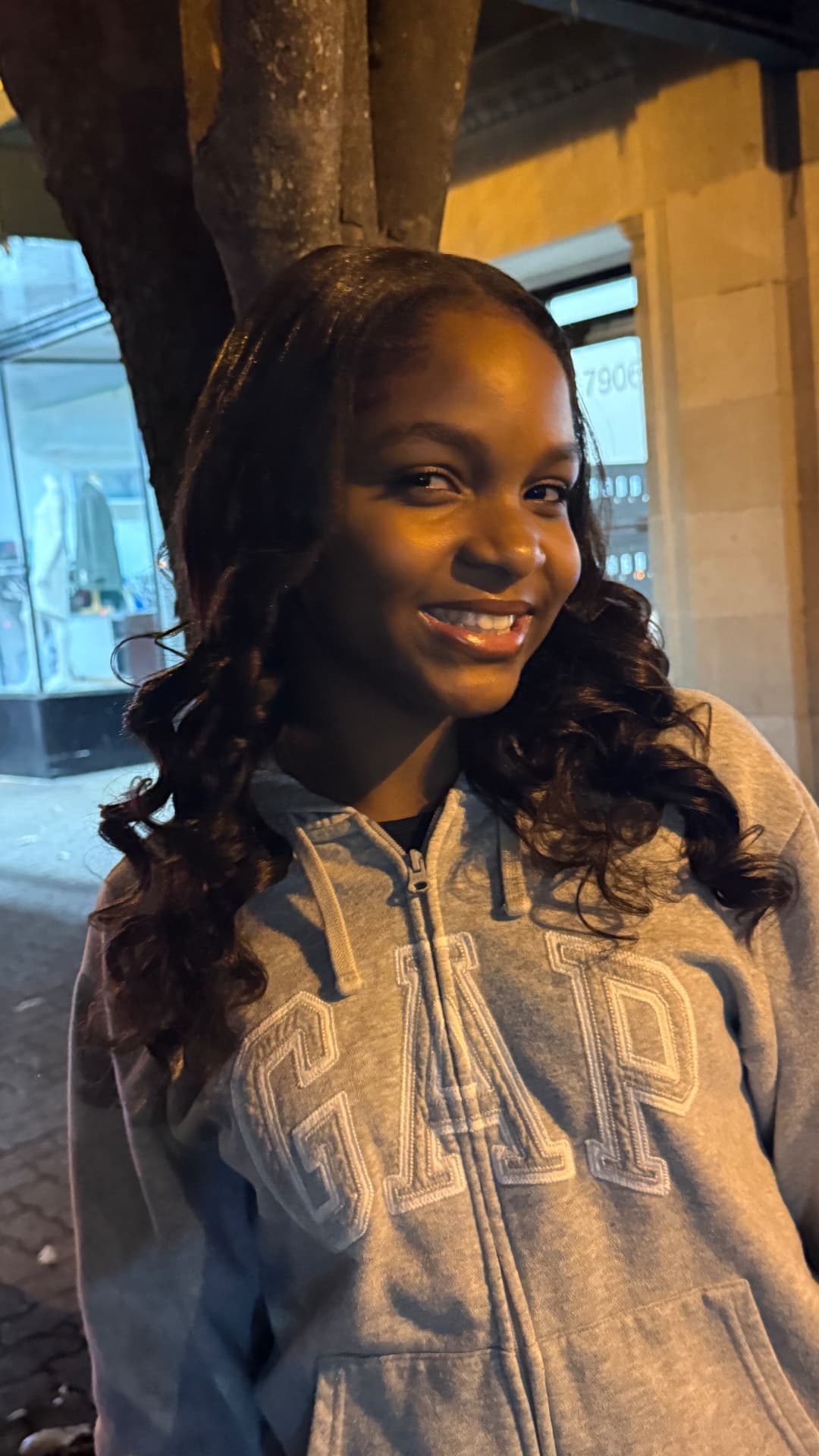 Asherah Anu smiling on an evening street